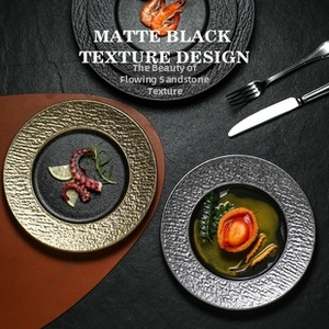 Detail of matte black ceramic plate with sand texture for luxury dining table decor