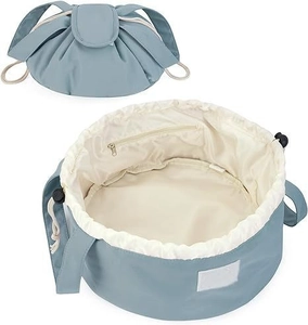 Detail view of the drawstring cosmetic bag showing its blue nylon fabric and inner pocket