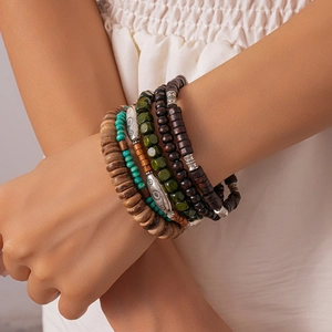 Bohemian multilayer bracelet set with vintage wood beads and ethnic charms on wrist