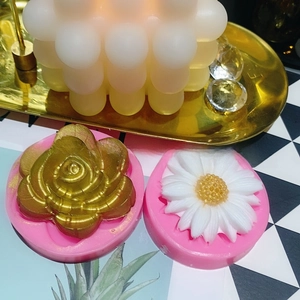 Detail view of silicone molds for crafting sunflower and daisy shapes for cake and candle