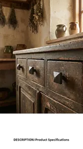 Close-up of vintage cast iron drawer handle in pyramid shape on rustic wooden cabinet