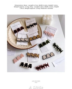Macro detail of acetate animal hair clips with size measurements on white tray