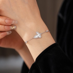 Close-up of butterfly bracelet featuring white mother-of-pearl and cubic zirconia