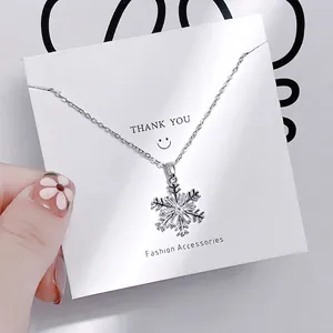 Macro shot of silver snowflake pendant necklace with sparkling cubic zirconia pavé