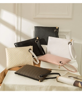 Various crocodile pattern wristlet clutches in black, white, and pink on a white surface