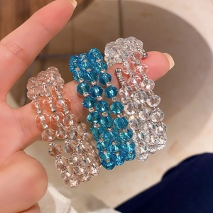 Detailed close-up of triple-layer crystal beaded wrap bracelet with rhinestone spacers