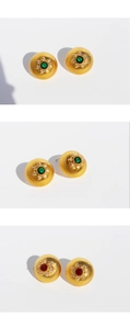 Macro view of vintage round stud earrings with brushed gold metal and zircon flower halo