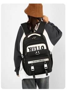 Close-up of the black backpack's side buckle and adjustable strap for heavy loads