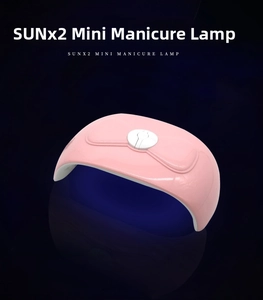 Detailed top view of pink SUNx2 mini UV LED nail lamp with cute bow-knot design