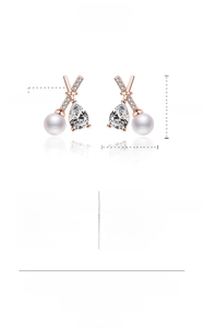 Detailed view of teardrop pearl earrings with 16.2mm height and zircon-encrusted X-shape