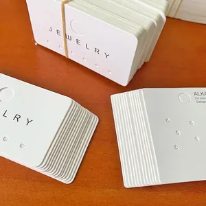 Bulk set of premium white jewelry display cards for earrings and necklaces on wood