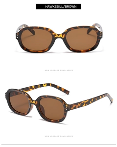 Close-up of tortoise shell sunglasses with dark brown lenses and classic double-stud design