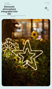 Outdoor solar star and snowflake garden stake lights with warm LED glow in night garden