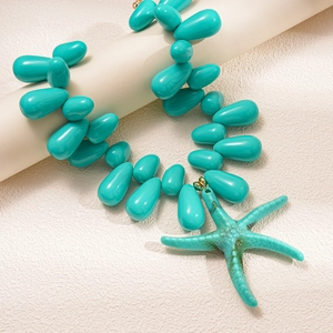 Detailed macro view of Tiffany blue acrylic beads and large starfish pendant necklace