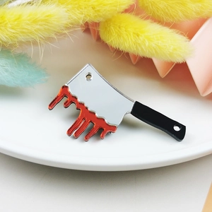 Macro view of acrylic bloody knife pendant with mirror finish for Halloween jewelry