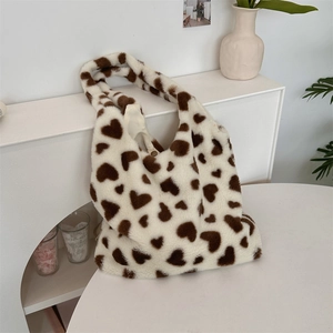 Detail of plush heart-pattern tote bag showing faux fur texture and magnetic closure