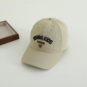 Detail of breathable perforated holes and bear embroidery on quick-dry kids baseball cap