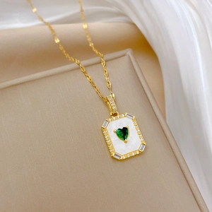 Gold titanium steel necklace featuring a green heart gemstone and shell inlay pendant