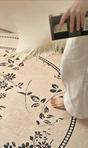 Detailed macro of thick floral art rug featuring beige tassels and soft woven texture