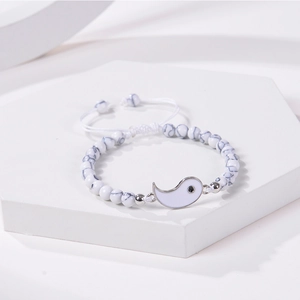 Detail of handmade Tai Chi bracelet featuring white marble beads and adjustable cord