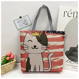 Detail of cute cartoon cat embroidery on striped canvas tote bag with princess text