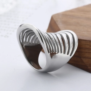 Fashionable hollow silver steel line ring with minimalist ribbed design on wood base