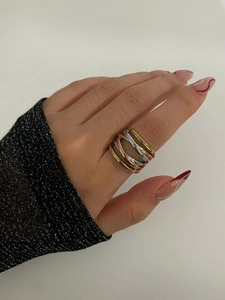 Detail of three-tone intertwined gold silver and rose gold polished stainless steel ring