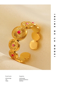 Detailed close-up of 18K gold plated ring with radial texture and pink enamel dots