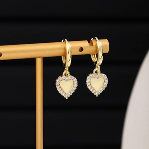 Close-up of elegant gold heart-shaped earrings with sparkling cubic zirconia pavé setting