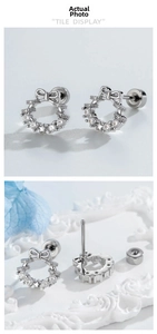 Detailed view of silver bow-shaped cartilage stud with cubic zirconia and screw-back closure