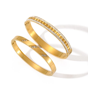 Gold stainless steel bracelet set with white crystals featuring minimalist clasp design
