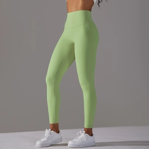 Close-up of light green high-waisted yoga leggings showing seamless waistband and fit