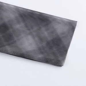 Detail of grey tie-dye mesh fabric with breathable texture for women's two-piece set