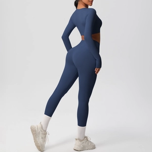 Close-up of deep blue high-waist yoga set with long sleeve crop top and leggings