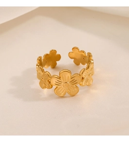 Detail of adjustable gold flower ring with textured daisy petals and open band design
