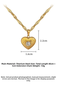 Detailed view of heart pendant with zircon stone and textured finish on twisted gold chain