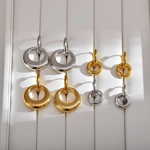 Polished double-loop stainless steel hoop earrings in gold and silver set on white background