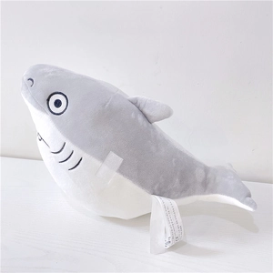 Detailed view of shark plush toy with soft embroidery eyes and white fabric wash label