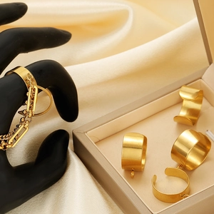 Luxurious gold-plated stainless steel ring set with minimalist wide bands on silk