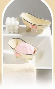 Detail of bathtub-shaped soap dish in cream yellow with pink bow and silver trim finish