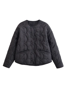 Detail view of the black wave quilted jacket with buttons and a round neckline