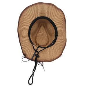 Detail of woven straw sun hat featuring brown edge binding and adjustable chin strap