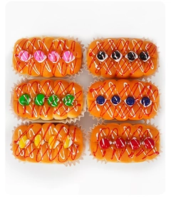 Top view of six colorful PU slow rebound fake cupcakes with striped frosting and fruit balls