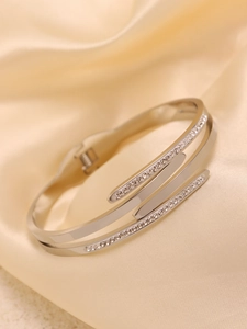 Detail shot of three-layer silver-tone pavé set zircon and polished stainless steel cuff