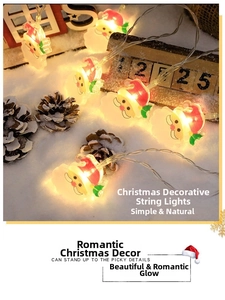 Detail of Santa Claus LED string lights on snow with festive warm yellow glow decorations