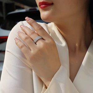 Detailed view of silver pavé eternity ring with rows of sparkling moissanite on finger