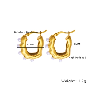 Detail view of 22mm gold irregular hoop earrings with small pearls and high polish finish