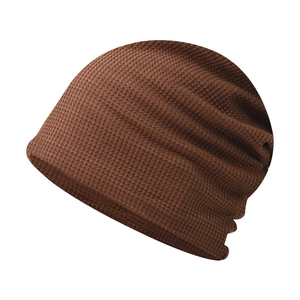 Detailed view of brown waffle knit beanie showing soft texture and elastic fabric