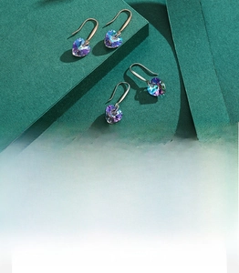 Detailed macro view of heart-shaped multifaceted crystal earrings with s925 silver hooks