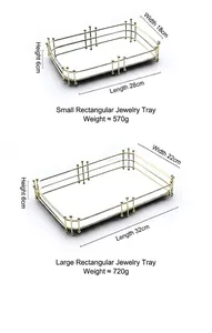 Detail showing dimensions of golden rectangular metal mirrored trays with ball feet support